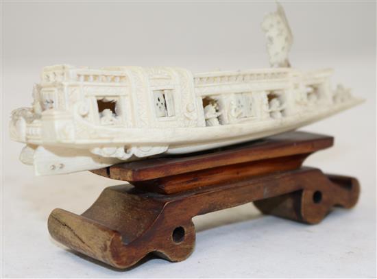 A Chinese ivory model of a boat, early 20th century, 15.5cm, wood stand